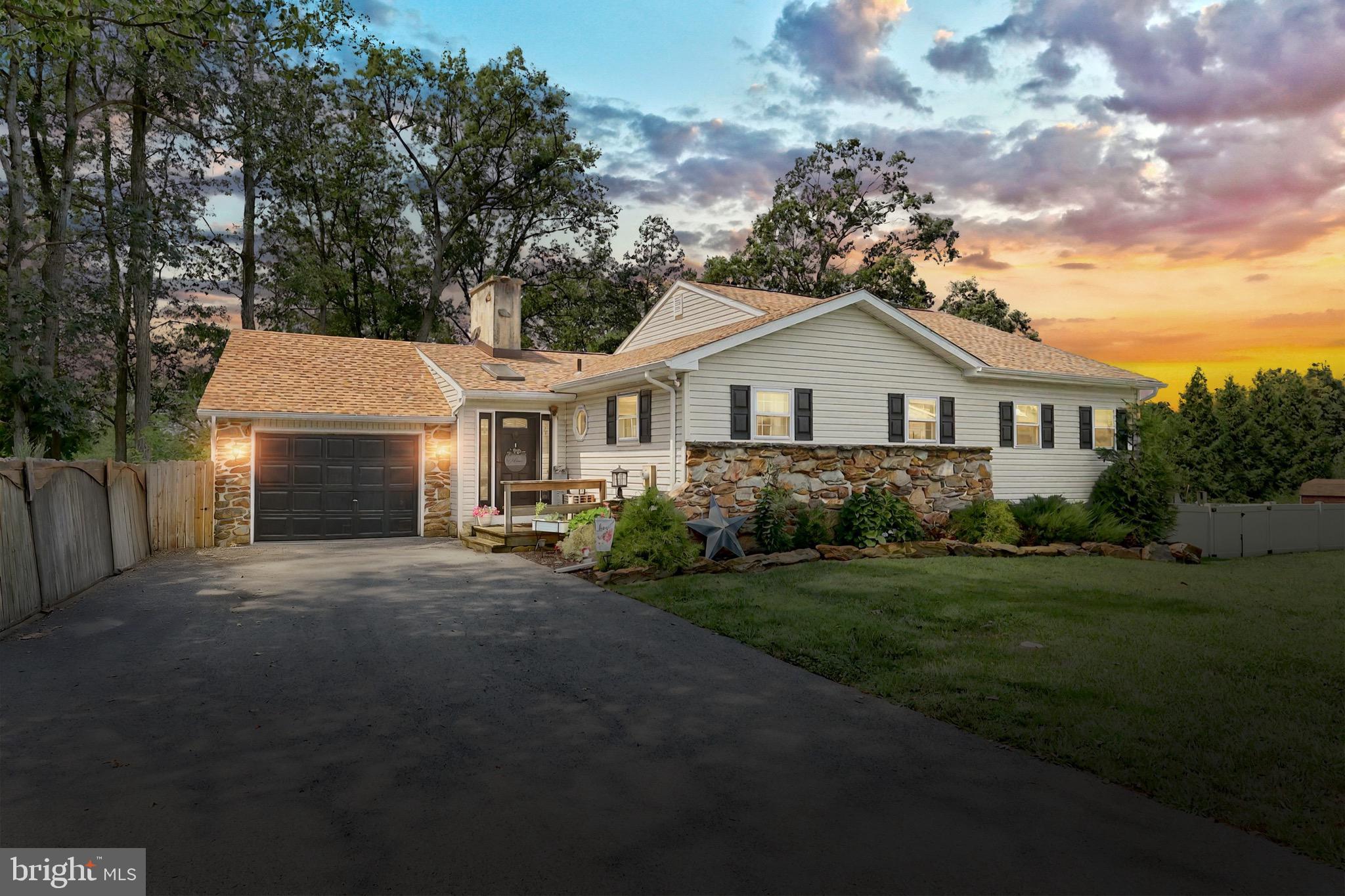 60 Massa Drive Windsor, PA 17366 - Photo 1 of 40 a front view of a house with a garden and trees
