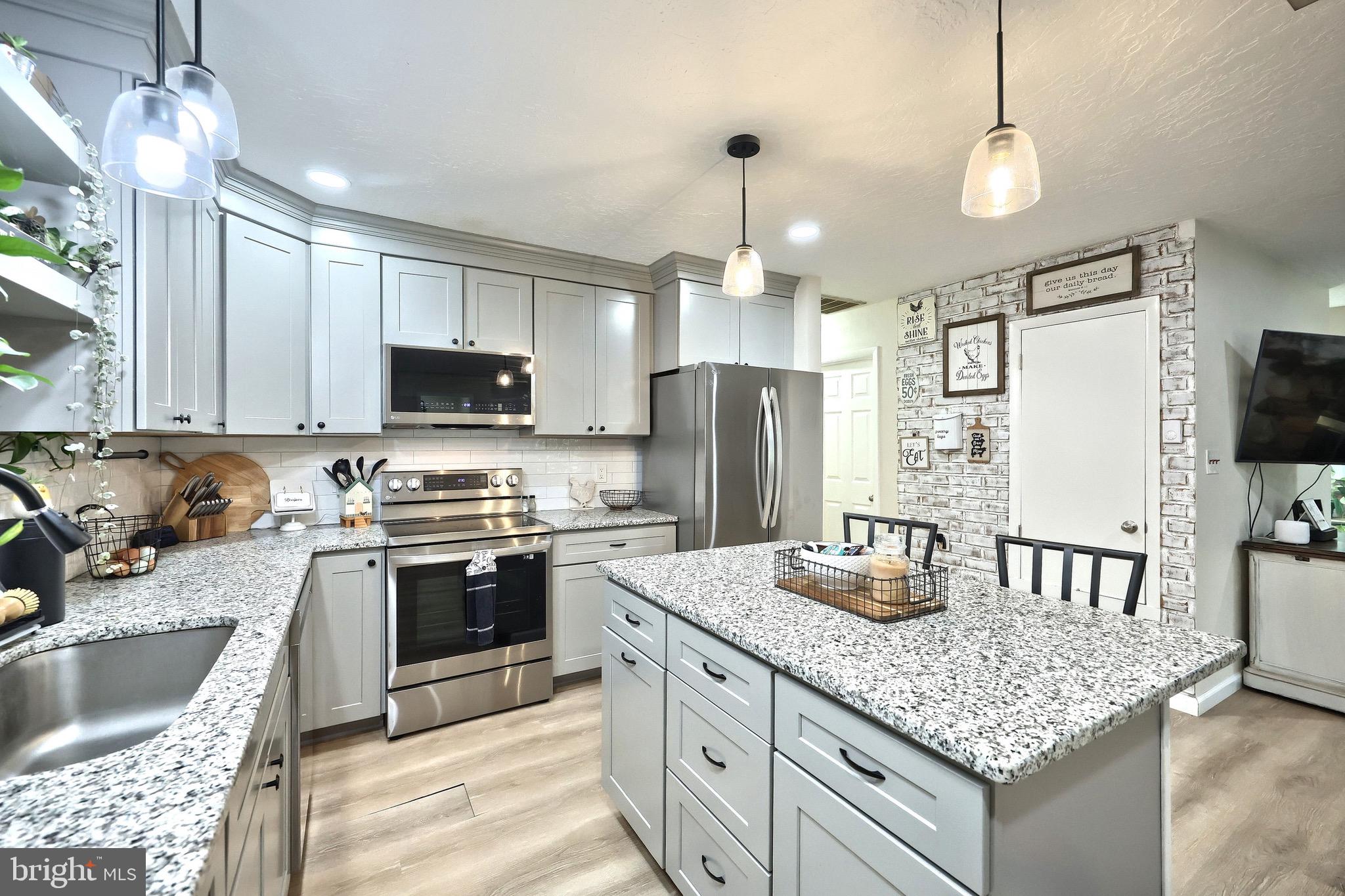 60 Massa Drive Windsor, PA 17366 - Photo 25 of 40 a kitchen with stainless steel appliances granite countertop a sink stove and refrigerator
