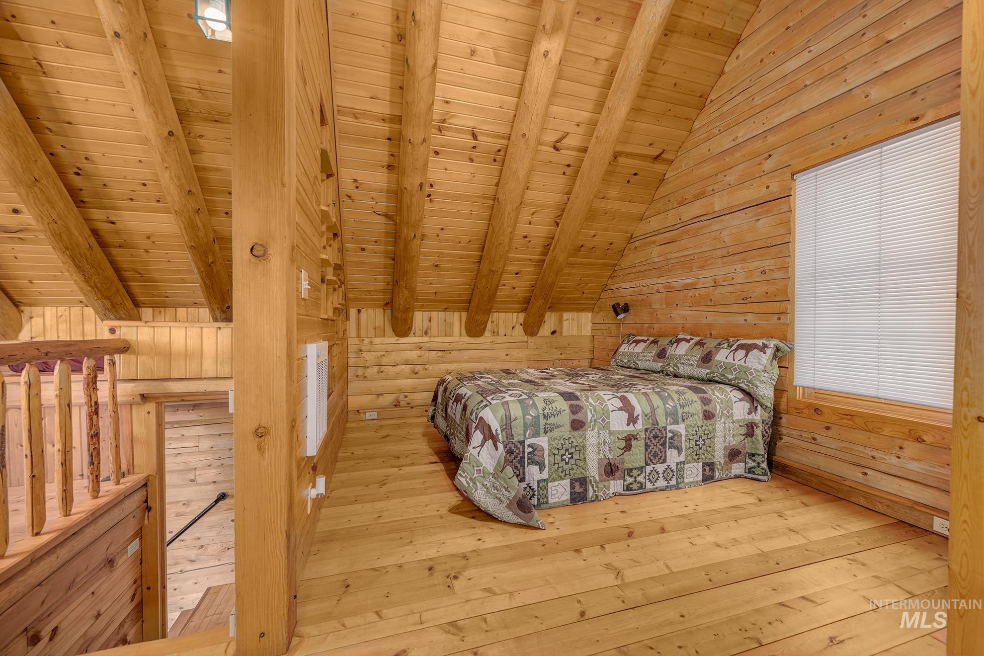 2150 Seid Creek Road Cambridge, ID 83610 - Photo 44 of 50 Loft sleeping area featuring natural wood walls and ceiling with exposed beams