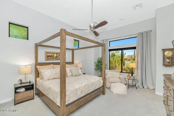 a bedroom with a large bed and a window