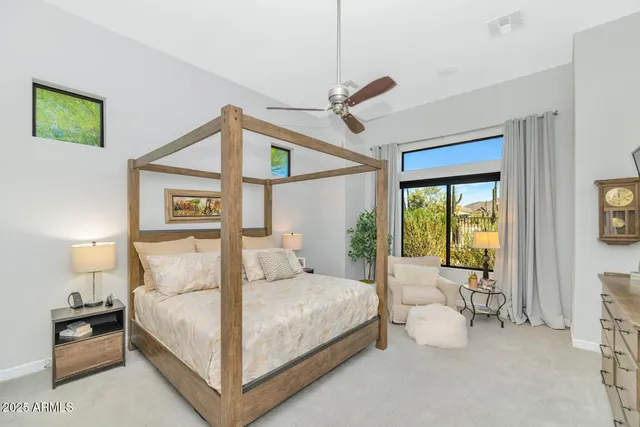 a bedroom with a large bed and a window