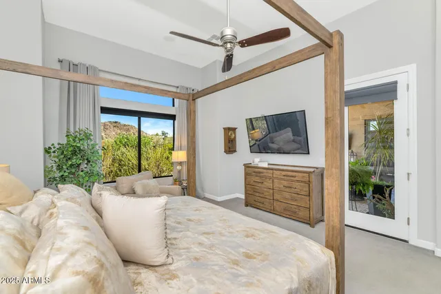 a spacious bedroom with a bed and a painting on the wall