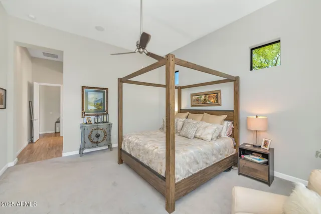 a bathroom with a sink a large mirror and a bathtub next to a window