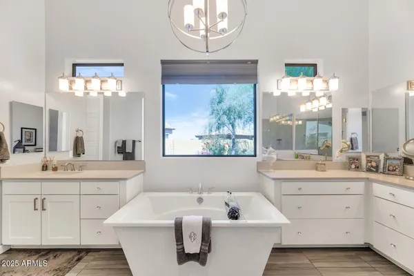 a bathroom with a sink shower and a mirror