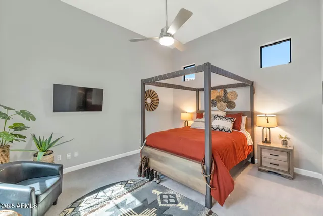 a bedroom with a bed and a large window