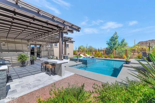 a view of a house with backyard sitting area and garden