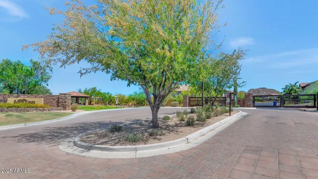an aerial view of residential houses with outdoor space and ocean view