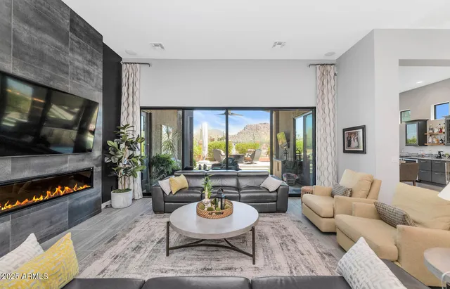 a living room with furniture and view of kitchen