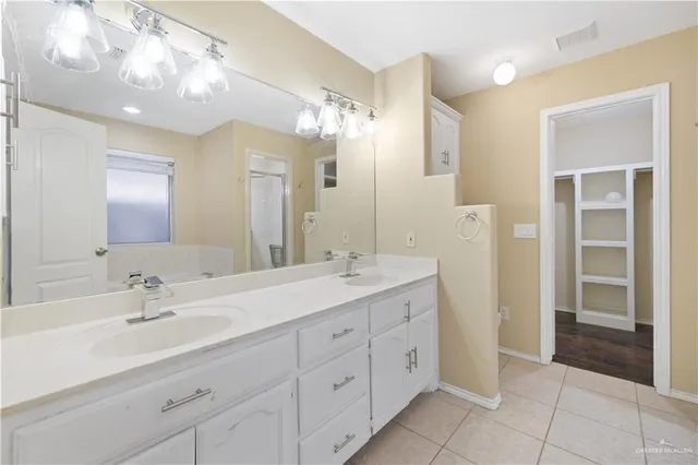 a bathroom with a double vanity sink and a mirror