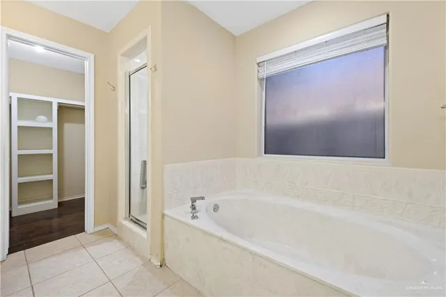 a spacious bathroom with a bathtub and a shower