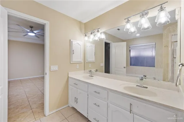 a bathroom with a double vanity sink and a mirror