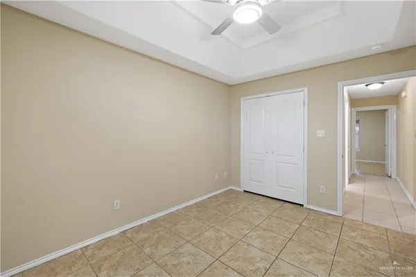 an empty room with a chandelier fan