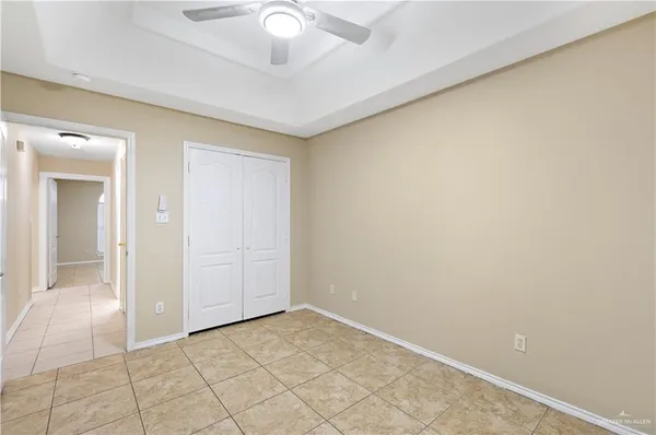 an empty room with a chandelier fan
