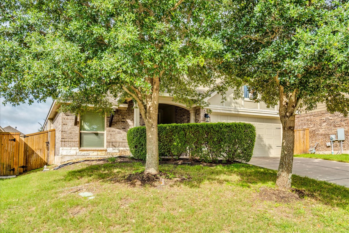 124 Compass Lane Kyle, TX 78640 - Photo 36 of 38 a view of a house with a tree in the yard