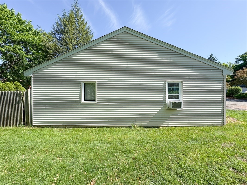 103 Main Street, Unit 10 Pepperell, MA 01463 - Photo 19 of 22 a front view of a house with a yard
