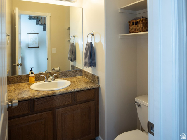 7532 North Castle Rock Road Eagle Mountain, UT 84005 - Photo 10 of 40 Main Floor Half bath featuring vanity and toilet