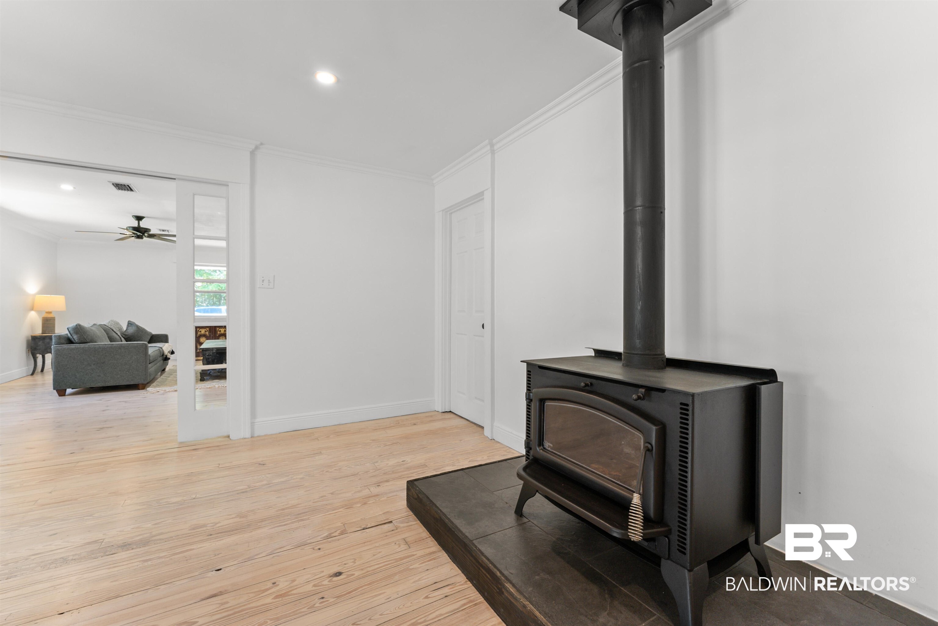6447 Bemis Lane Bon Secour, AL 36511 - Photo 27 of 62 Freestanding wood-burning stove with a dark wood-finish hearth