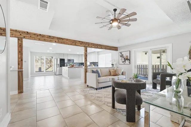 a view of a dining room with furniture and kitchen view