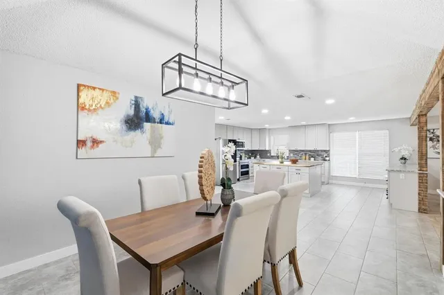 a large kitchen with cabinets and stainless steel appliances
