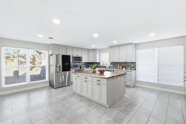 a kitchen with granite countertop cabinets and steel stainless steel appliances