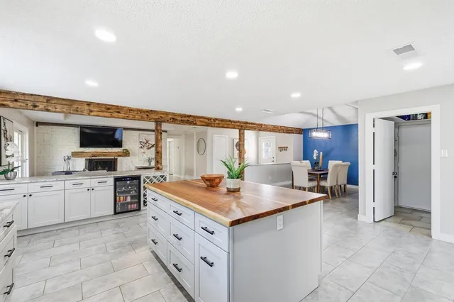 a kitchen with a sink dishwasher stove and cabinets