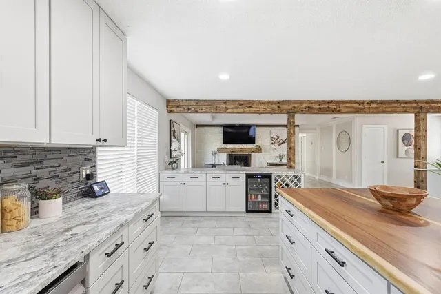 a kitchen with a sink and white cabinets
