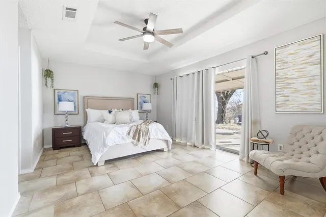 a bed sitting in a bedroom next to a bathroom