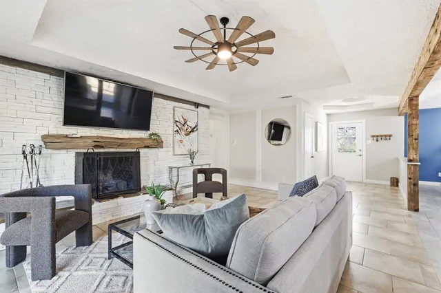 a living room with furniture a flat screen tv and a fireplace