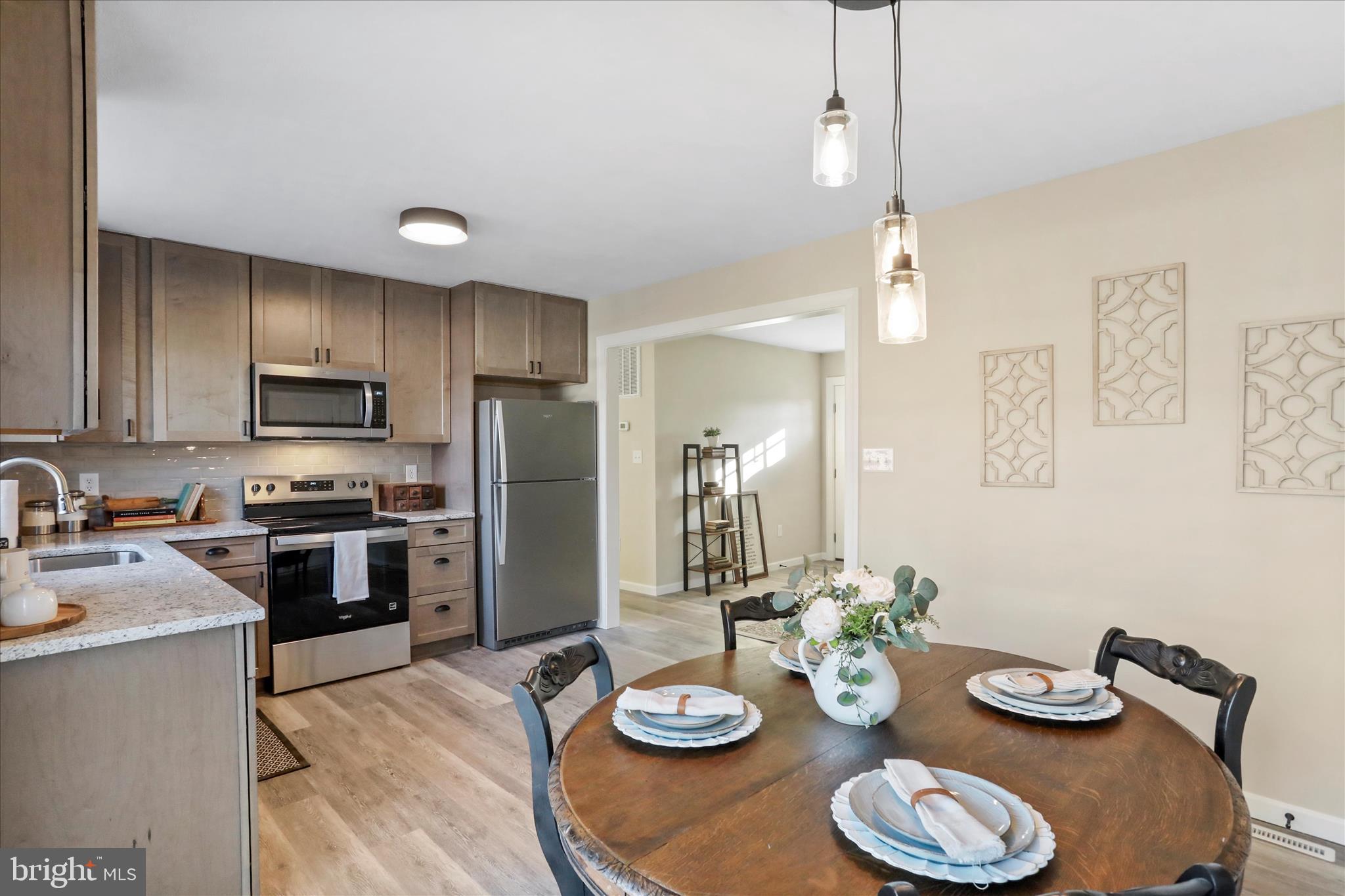 1517 Kendrick Ford Road Front Royal, VA 22630 - Photo 12 of 39 a kitchen with granite countertop stainless steel appliances a dining table and chairs in it