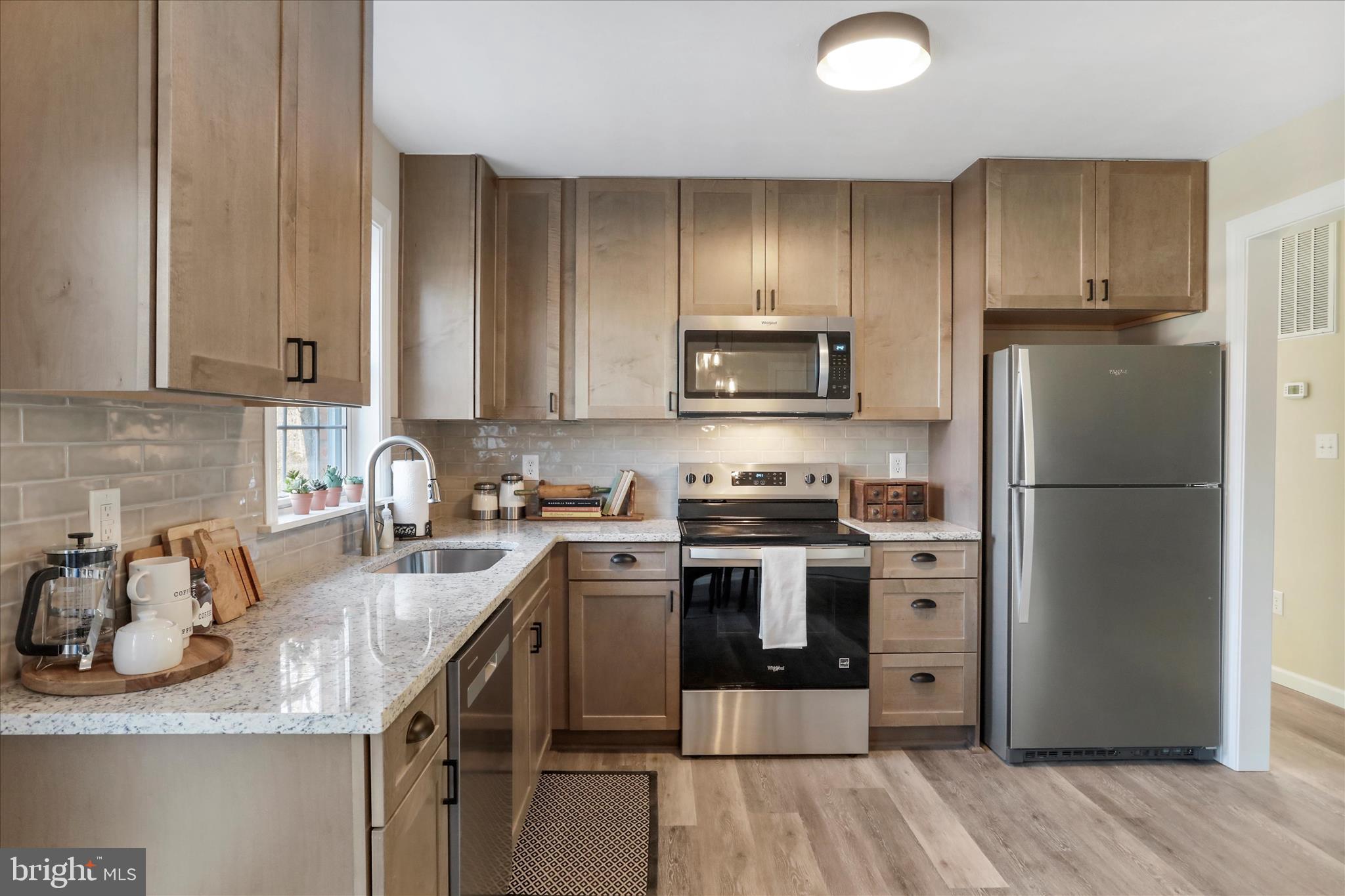 1517 Kendrick Ford Road Front Royal, VA 22630 - Photo 2 of 39 a kitchen with granite countertop a refrigerator stove and sink