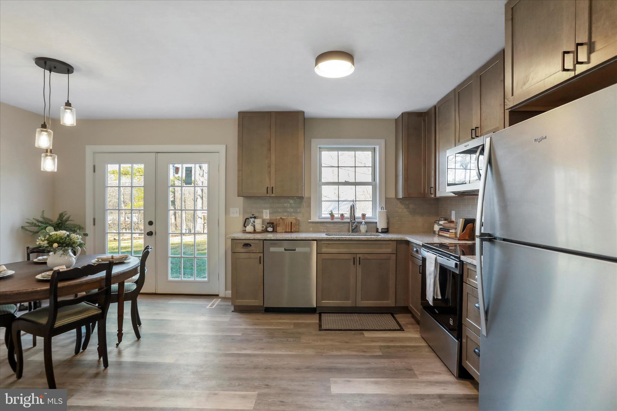 1517 Kendrick Ford Road Front Royal, VA 22630 - Photo 5 of 39 a kitchen with a refrigerator and a stove top oven