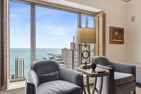 a living room with furniture a rug and a window