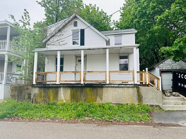 a view of a house with pool yard and sitting area