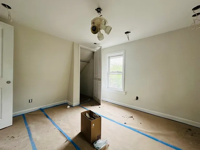 a white house that has a tree in front of it