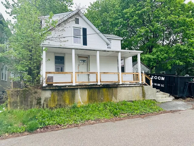 a front view of a house with a garden and swimming pool