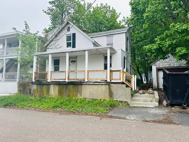 a view of house with outdoor space and trees in the background
