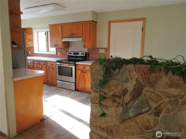 a kitchen with a refrigerator sink and stove