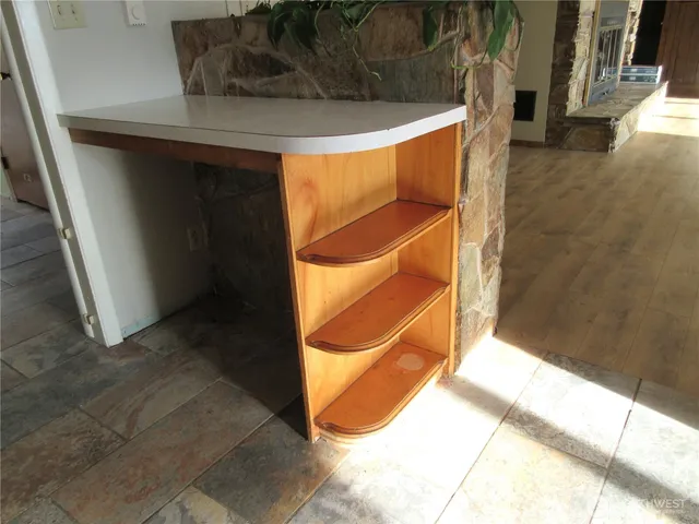 a bed room with a bed dresser and a chandelier