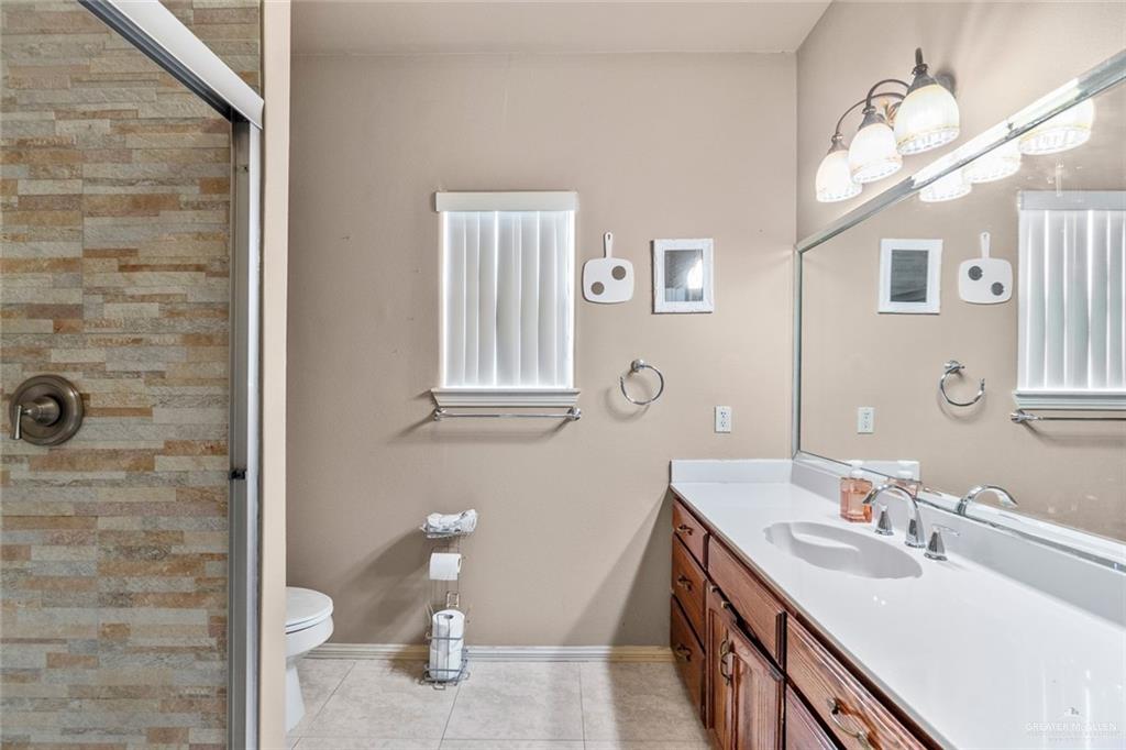 2904 Victoria Street Hidalgo, TX 78557 - Photo 14 of 25 Full bathroom featuring vanity, a stall shower, and light tile patterned flooring