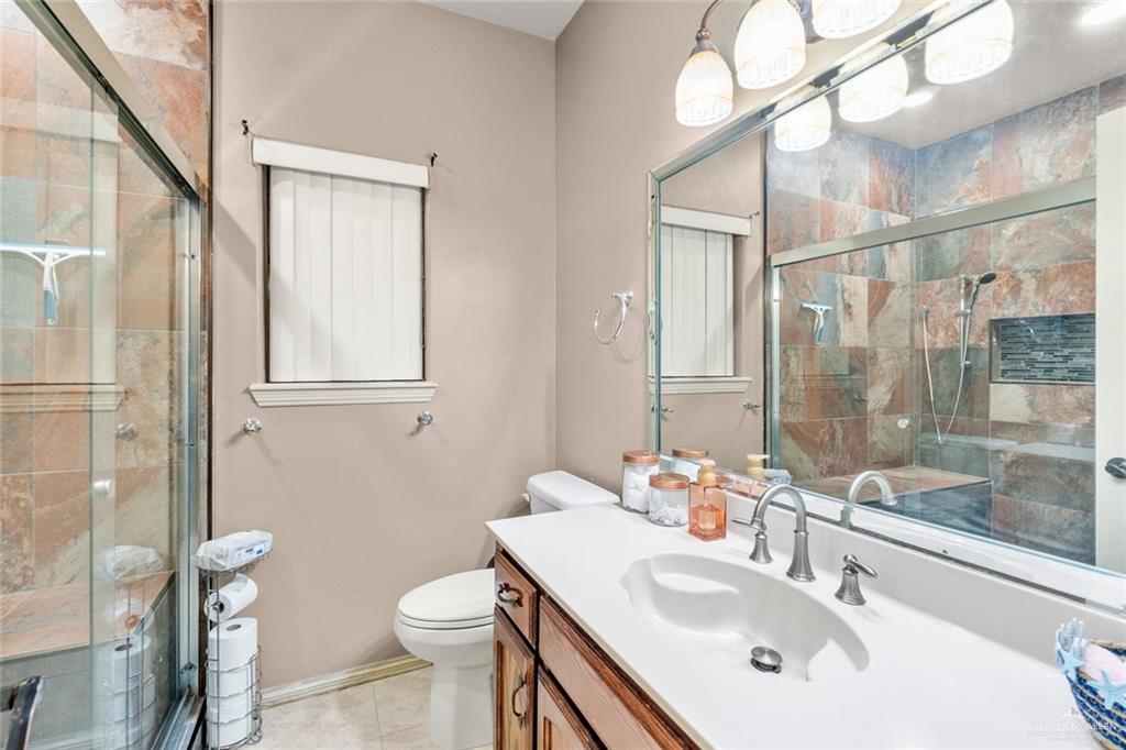 2904 Victoria Street Hidalgo, TX 78557 - Photo 18 of 25 Full bath with vanity, a shower stall, and light tile patterned floors