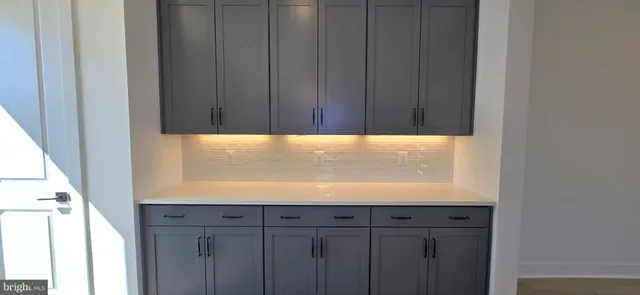 a kitchen with a stove a sink and a window