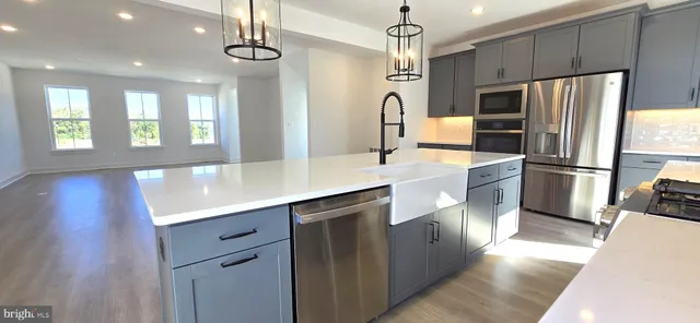 a kitchen with granite countertop cabinets and refrigerator