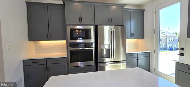 a kitchen with stainless steel appliances a stove and a refrigerator