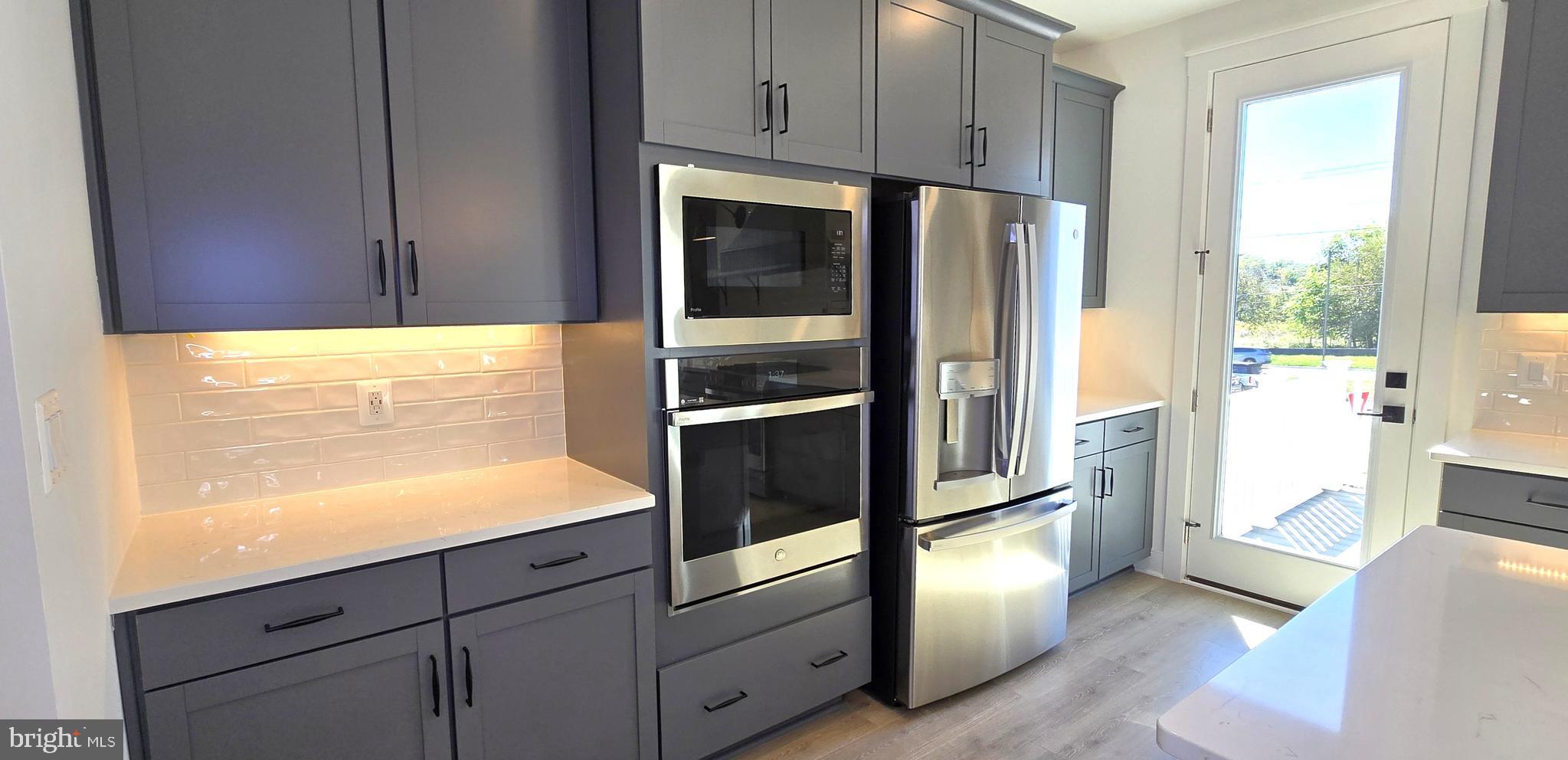 1726 Blacksmith Way Frederick, MD 21702 - Photo 21 of 64 a kitchen with granite countertop cabinets and refrigerator