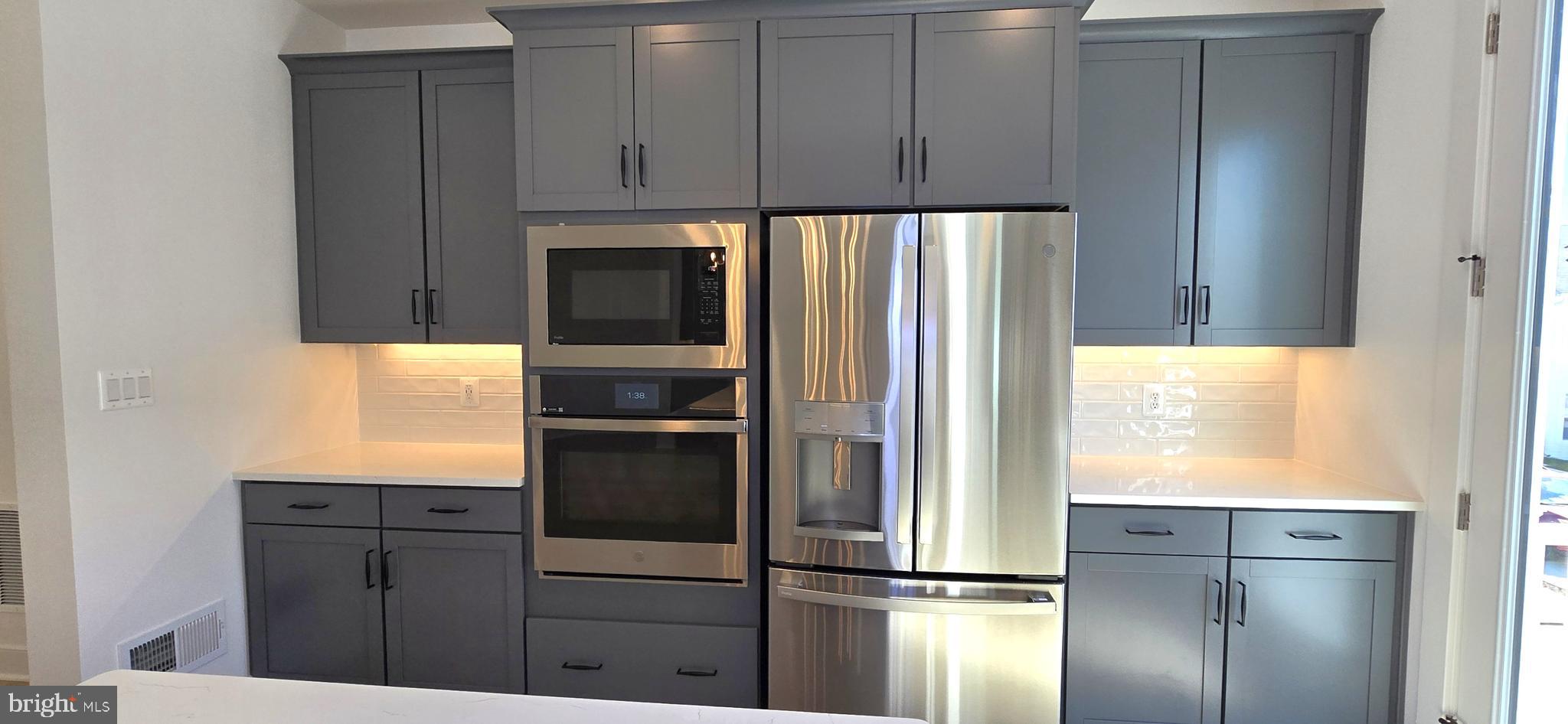 1726 Blacksmith Way Frederick, MD 21702 - Photo 25 of 64 a kitchen with stainless steel appliances granite countertop a refrigerator and a stove