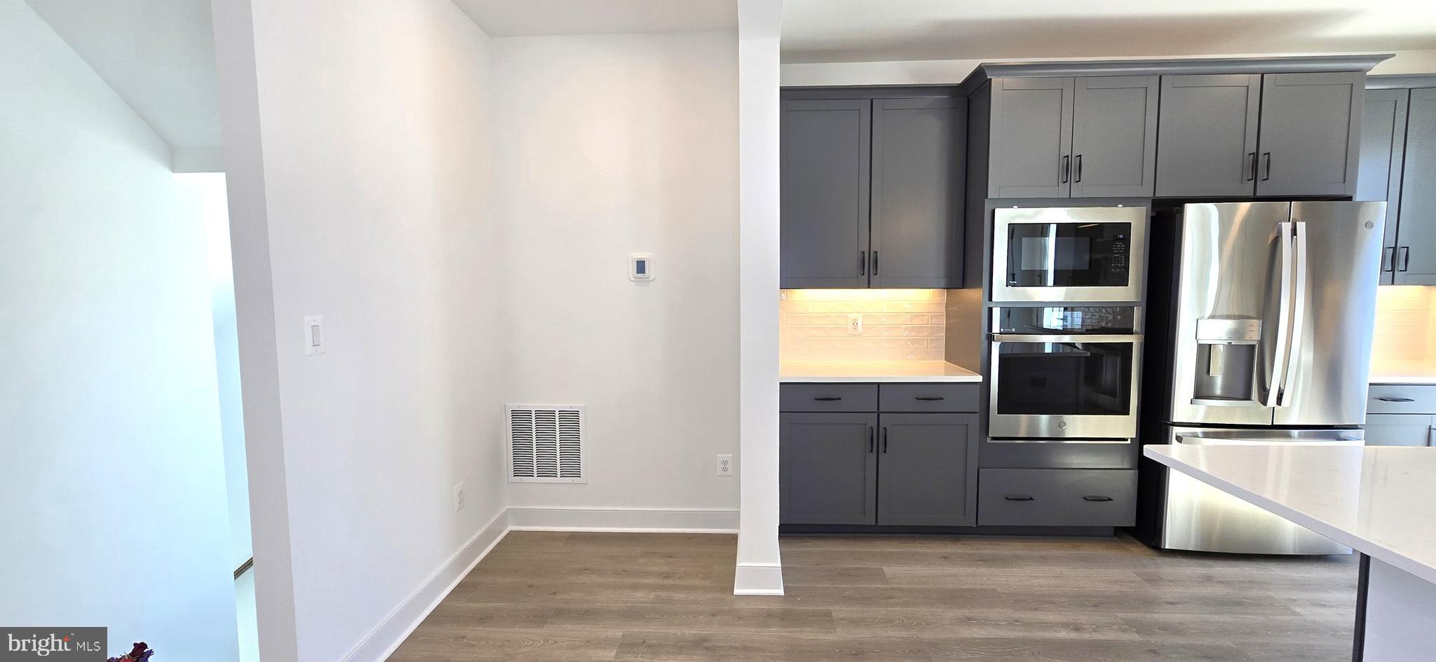 1726 Blacksmith Way Frederick, MD 21702 - Photo 27 of 64 a view of a kitchen with wooden floor and electronic appliances