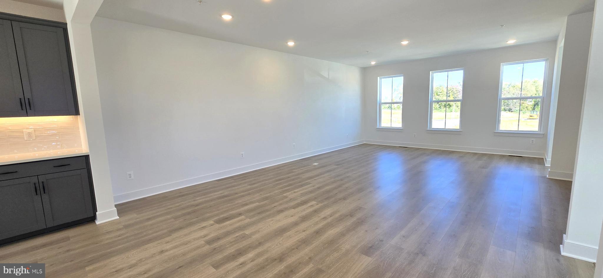 1726 Blacksmith Way Frederick, MD 21702 - Photo 29 of 64 a view of an empty room with wooden floor and a window