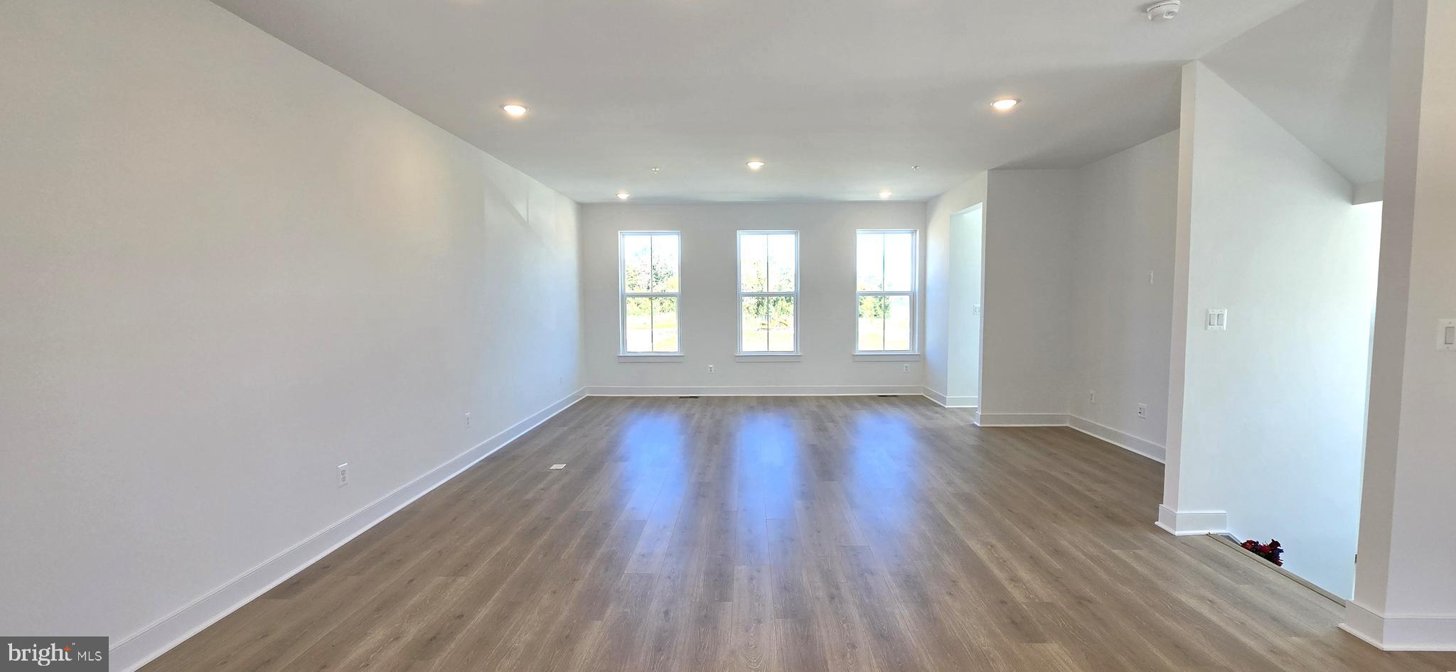 1726 Blacksmith Way Frederick, MD 21702 - Photo 30 of 64 a view of an empty room with wooden floor and window