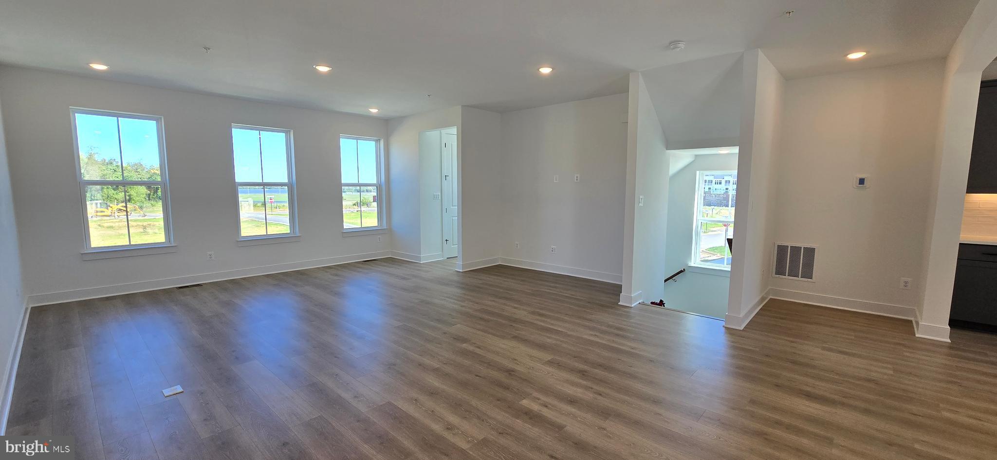 1726 Blacksmith Way Frederick, MD 21702 - Photo 31 of 64 a view of an empty room with wooden floor and a window