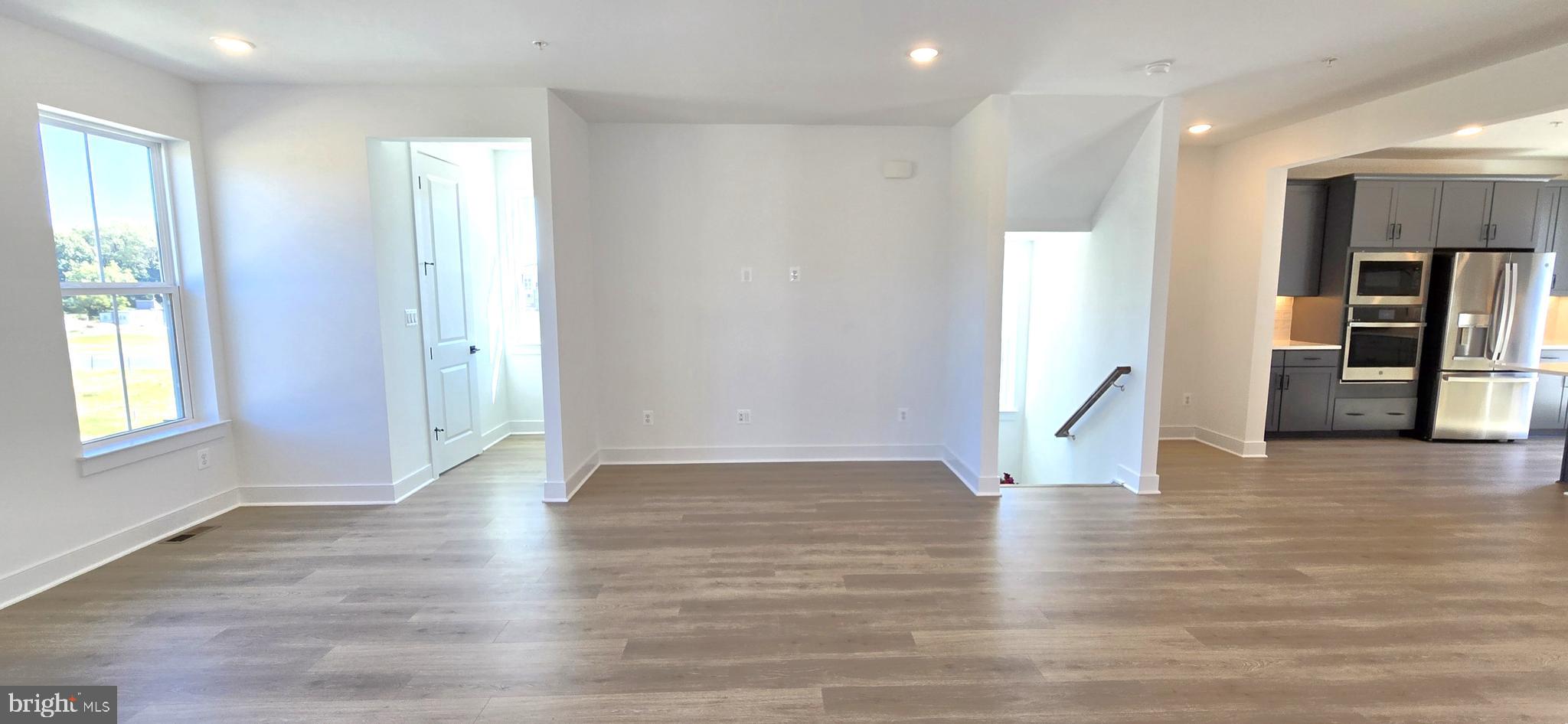 1726 Blacksmith Way Frederick, MD 21702 - Photo 32 of 64 an empty room with wooden floor and windows
